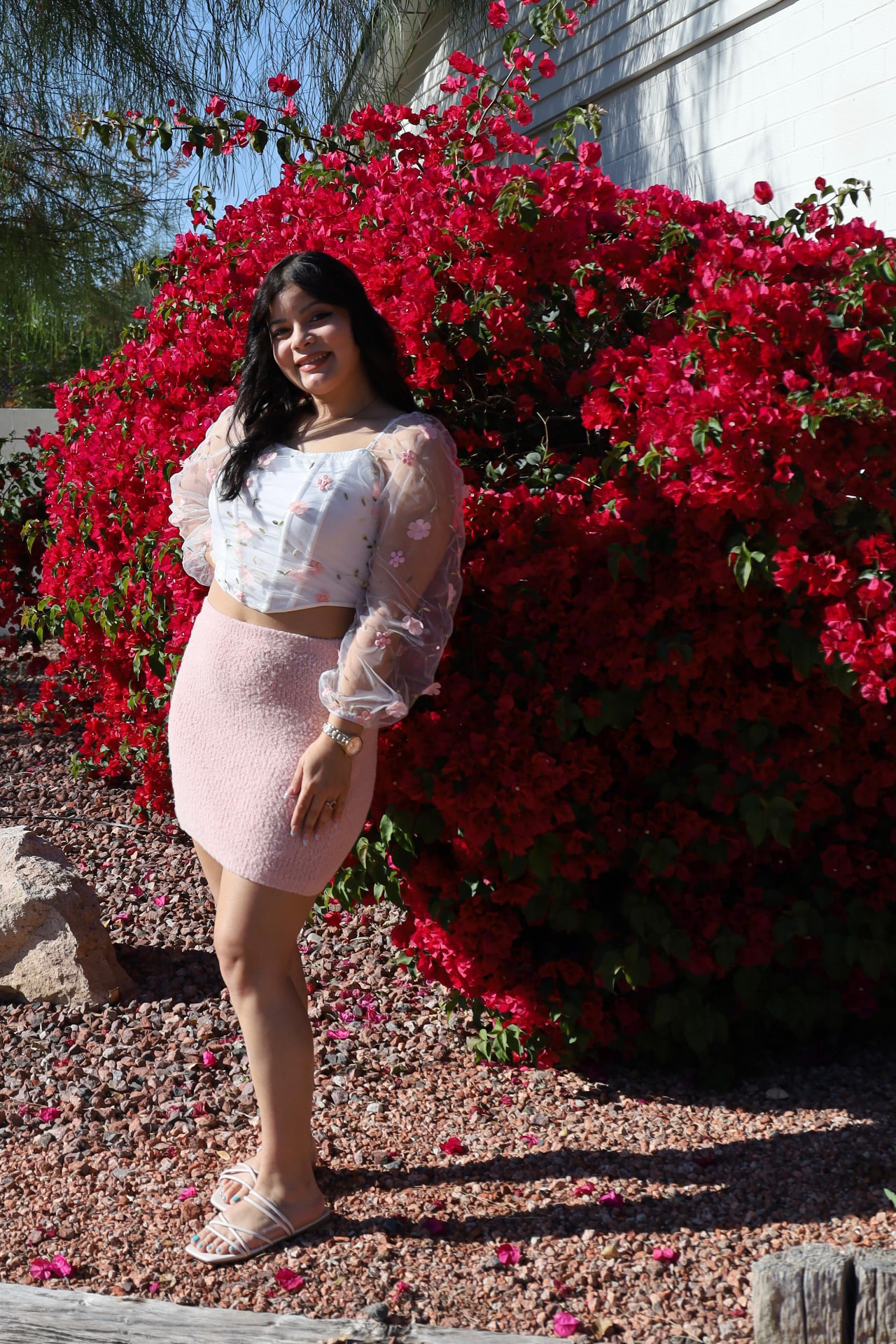Stephanie Luna in front of pink bougainvillea